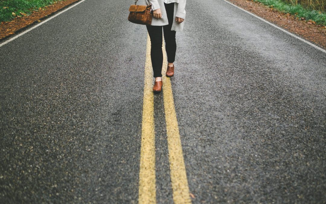 woman walking in the center of the road